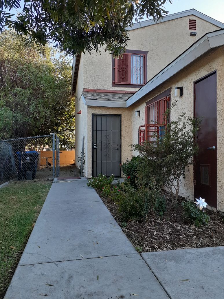 A house with a brown door and a red window.